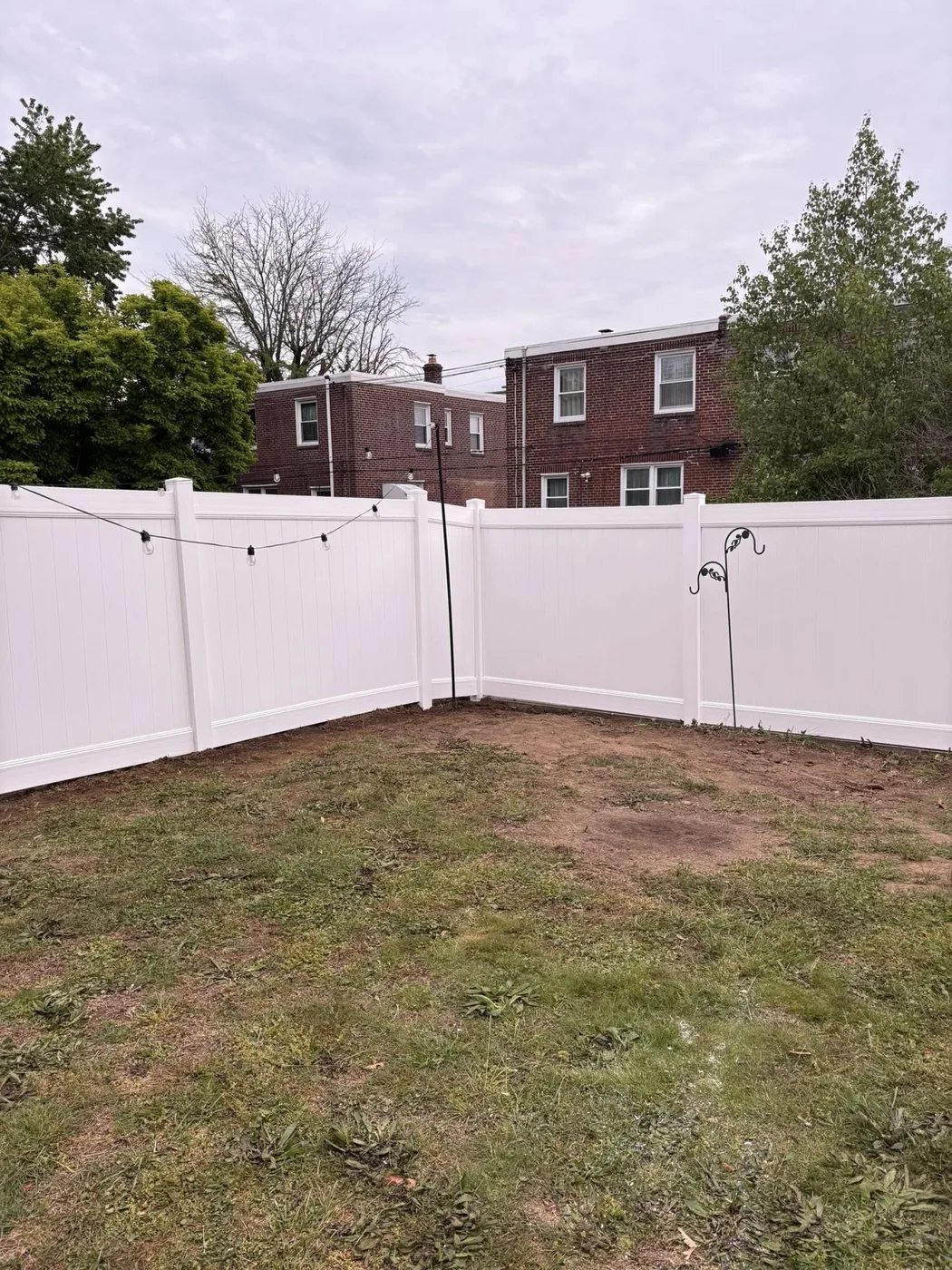 White vinyl privacy fence with patio lights
